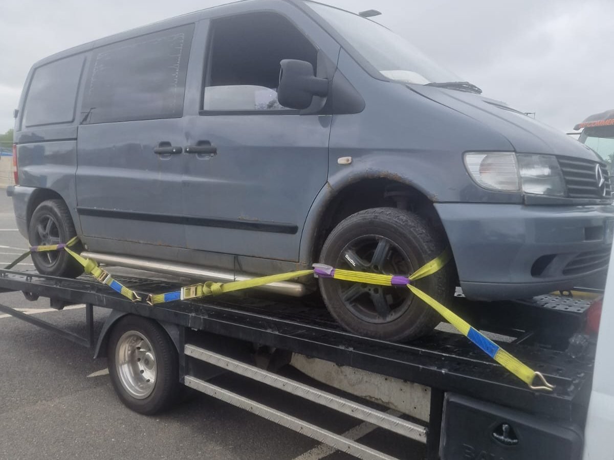 Mercedes Vito van strapped down with ratchet straps on a flatbed recovery truck